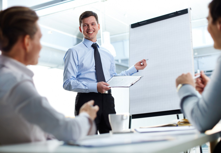 Cheerful businessman discussing a new business project with the members of his team